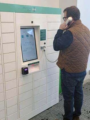 Patient speaking with a pharmacist at a DHMC Prescription locker